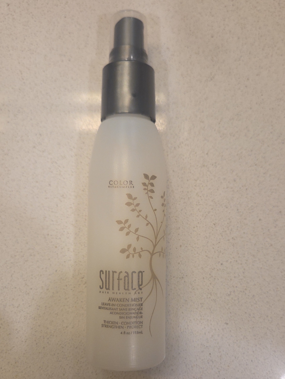 SURFACE Awaken Mist Leave-In Conditioner Spray in White and Silver.